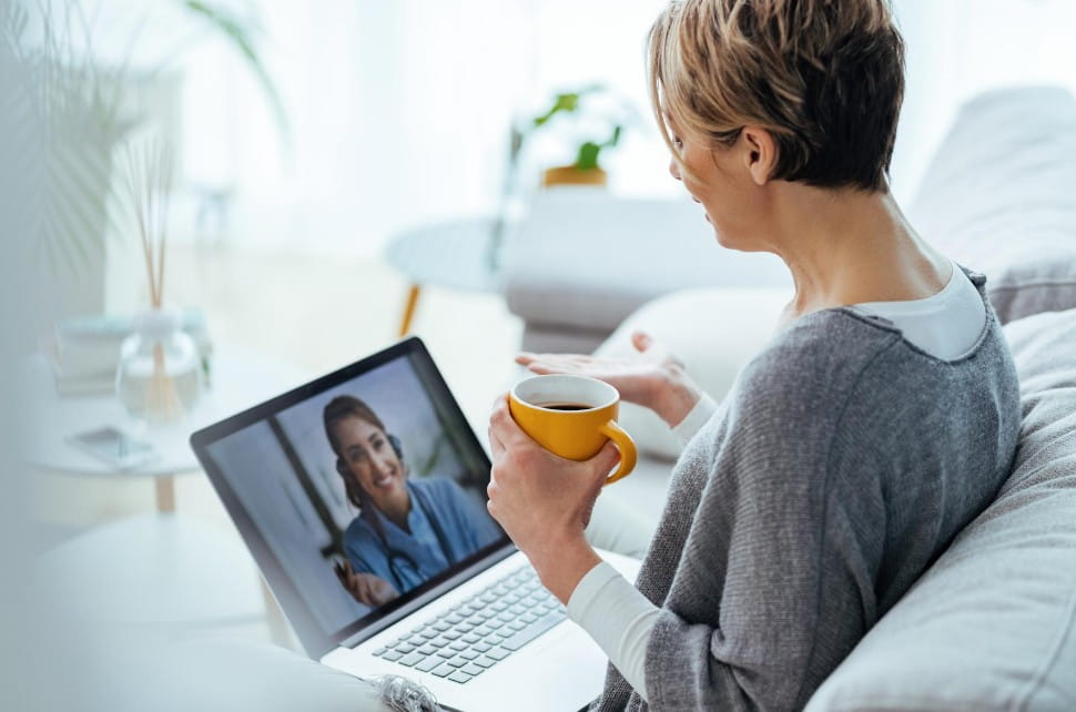 A woman participating in a virtual ADHD coaching session in a calm home environment
